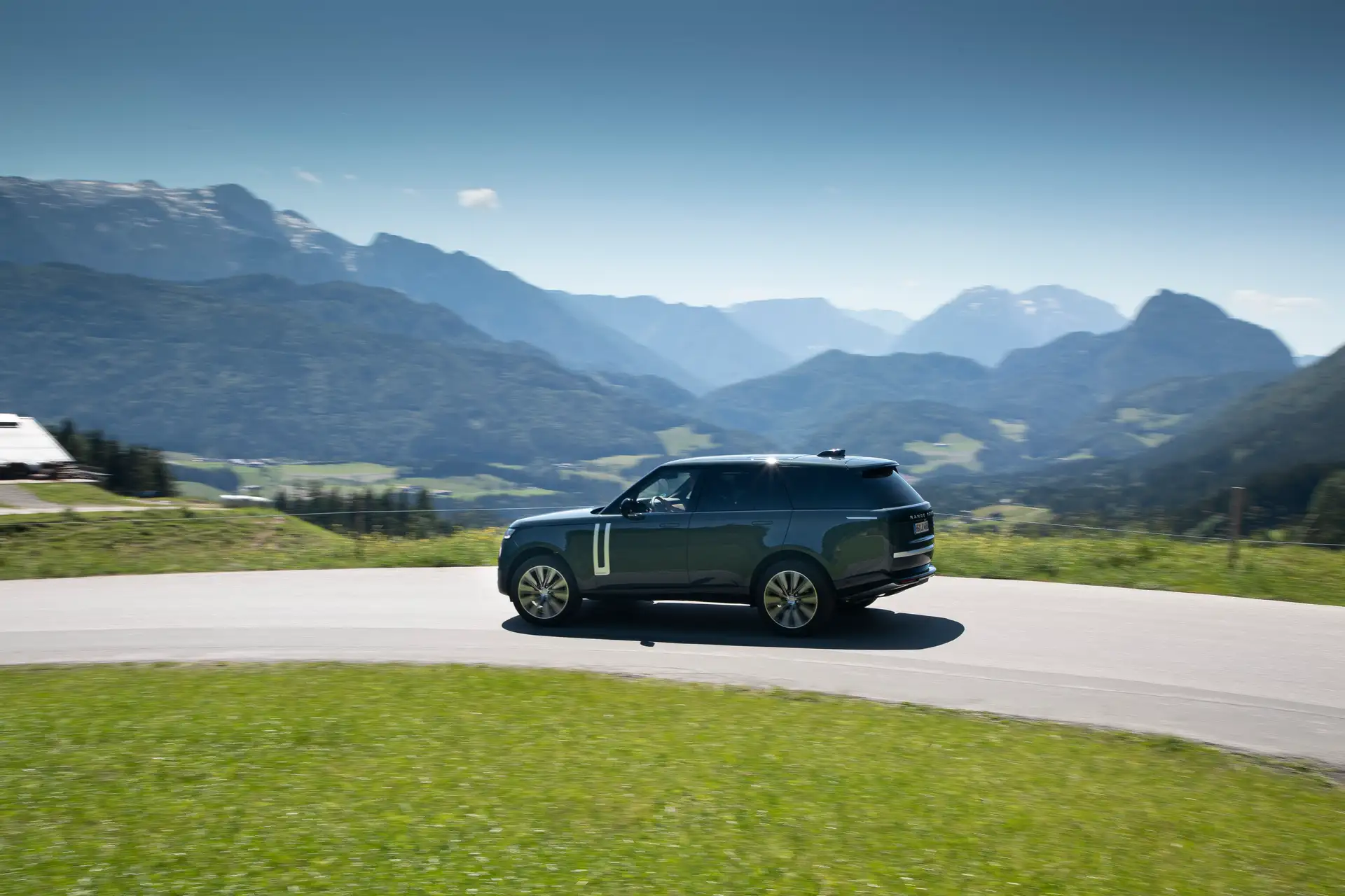 Side view of the Range Rover (Vogue) on a country road in the mountains.